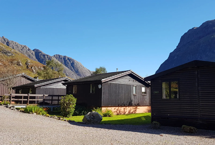 Clachaig Chalets with the mountains of Glencoe behind